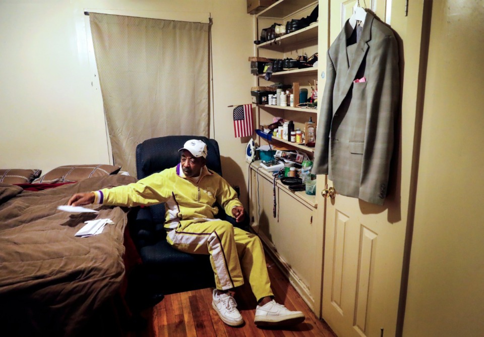 <strong>Marine Corps veteran Anton Siggers looks over paperwork in his room on Monday, Dec. 28, 2020 at Alpha Omega Veterans Services on Ball Street. </strong>(Mark Weber/The Daily Memphian)