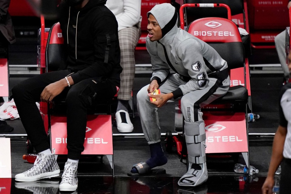 <strong>Memphis Grizzlies guard Ja Morant, right, wears a boot on his left foot after suffering an injury during the team's NBA basketball game against the Brooklyn Nets, Monday, Dec. 28, 2020, in New York.</strong> (Kathy Willens/AP)