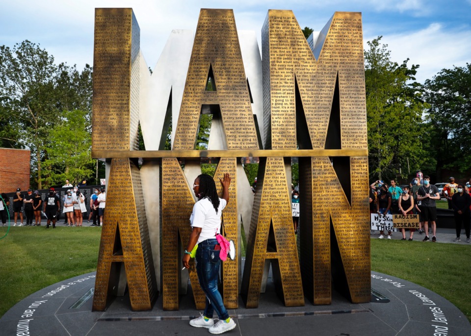 <strong>Barbara Buress quietly touches the I Am A Man statue in Memphis on Monday, June 1, 2020, during a protest over the Minneapolis death of George Floyd</strong>. (Mark Weber/Daily Memphian)