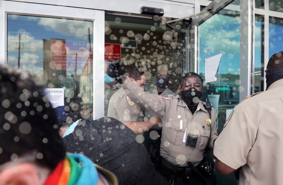 <strong>A Shelby County Sheriff's deputy pepper sprays a crowd of protesters gathered outside of 201 Poplar after they attempted to take the demonstration inside the building July 25, 2020.</strong> (Patrick Lantrip/Daily Memphian)