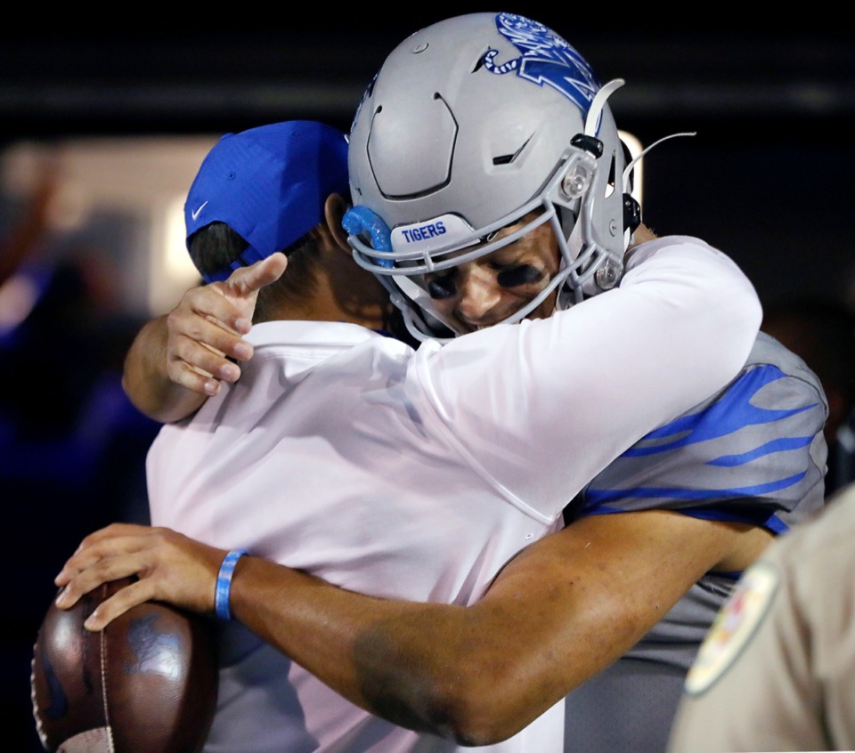 <strong>University of Memphis quarterback Brady White (3) gives head coach Ryan Silverfield a hug while holding the game ball after an Oct. 17, 2020 game against University of Central Florida at Liberty Bowl Memorial Stadium</strong>. (Patrick Lantrip/Daily Memphian)