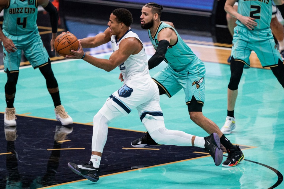 <strong>Memphis Grizzlies guard Desmond Bane drives to the basket as Charlotte Hornets' Cody Martin defends during the first half of an NBA basketball game in Charlotte, N.C., Friday, Jan. 1, 2021.</strong> (AP Photo/Jacob Kupferman)