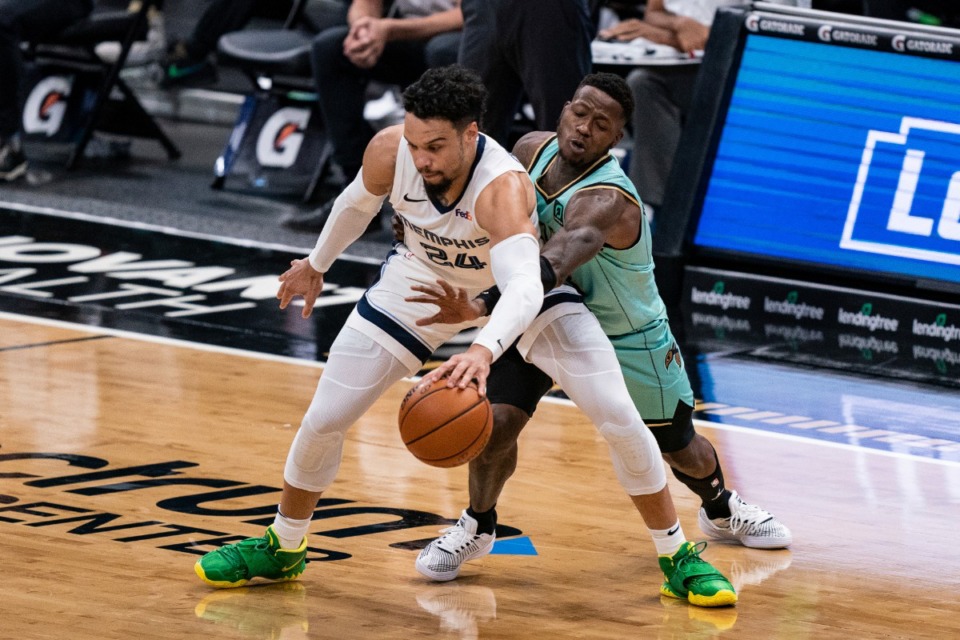 <strong>Charlotte Hornets guard Terry Rozier tries to knock the ball away from Memphis Grizzlies guard Dillon Brooks (24) during the first half of an NBA basketball game in Charlotte, N.C., Friday, Jan. 1, 2021.</strong> (AP Photo/Jacob Kupferman)