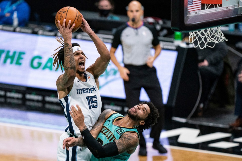 <strong>Memphis Grizzlies forward Brandon Clarke (15) fouls Charlotte Hornets forward Miles Bridges during the second half of an NBA basketball game in Charlotte, N.C., Friday, Jan. 1, 2021.</strong> (AP Photo/Jacob Kupferman)
