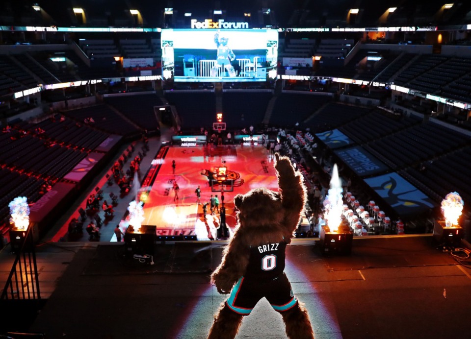 <strong>Grizz, the Memphis Grizzlies mascot poses in front of pyrotechnics in the nearly empty FedExForum before a Jan. 3, 2021 game against the Los Angeles Lakers.</strong> (Patrick Lantrip/Daily Memphian)