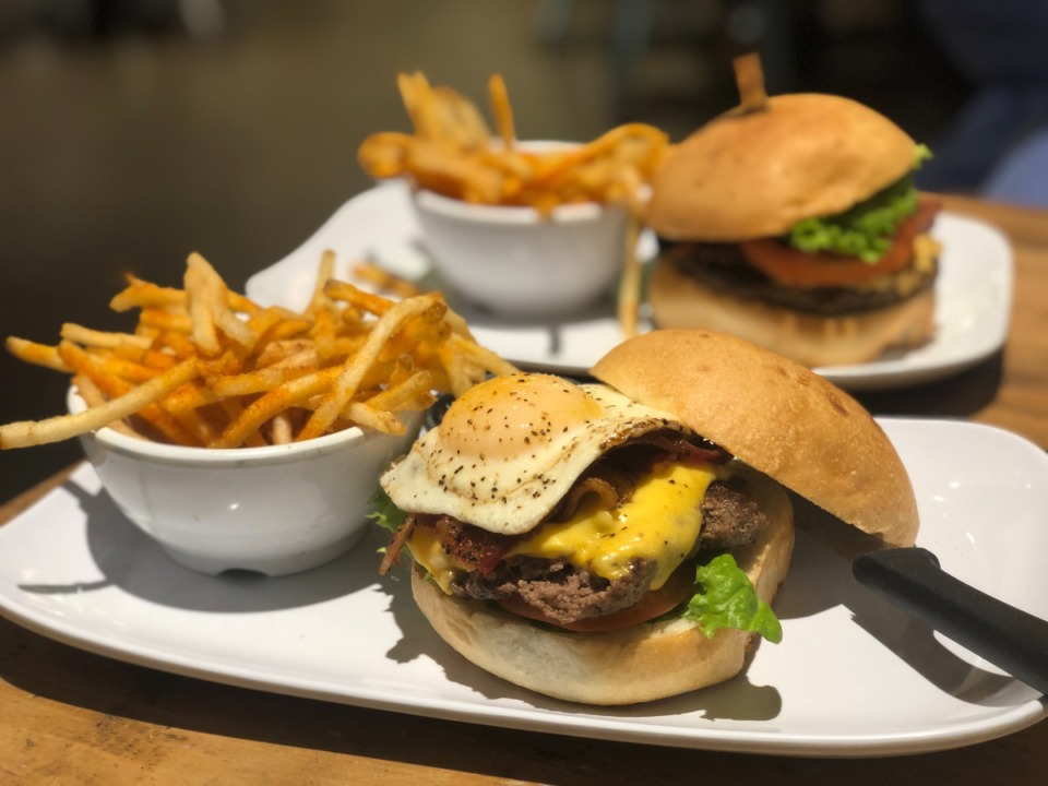 <strong>The Sunrise Burger (front) and the Bacon Pimento Cheese Burger are a Monday deal at Pimento&rsquo;s.</strong> (Jennifer Biggs/Daily Memphian)