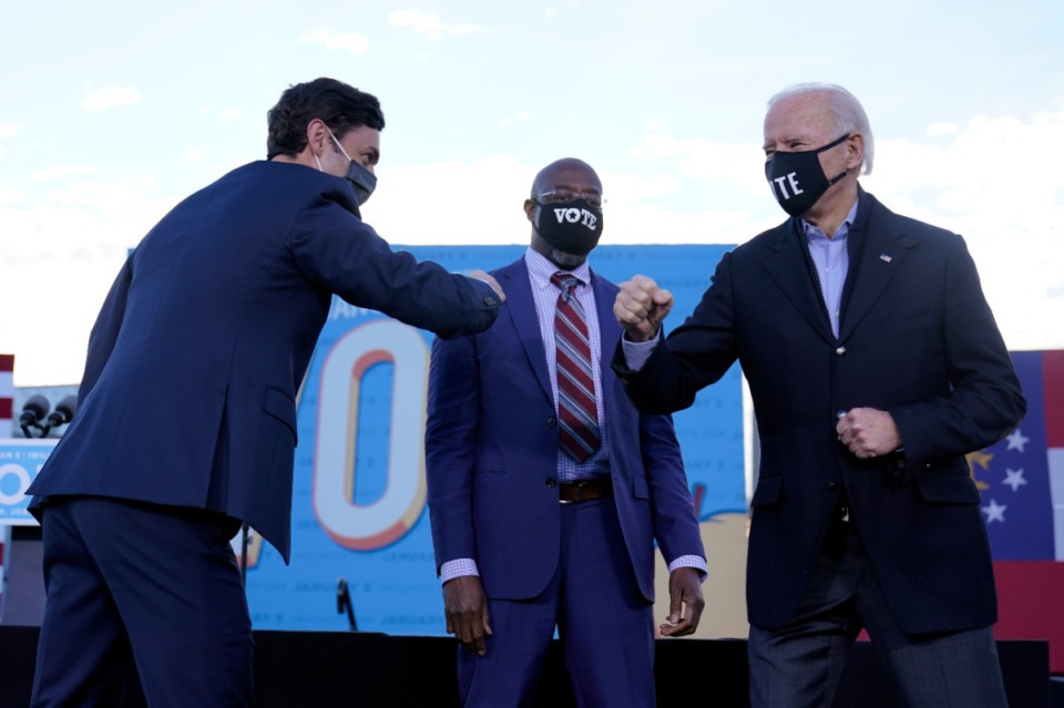 <strong>President-elect Joe Biden campaigns in Atlanta, Monday, Jan. 4, 2021, for Senate candidates Raphael Warnock, center, and Jon Ossoff, left. Both candidates have been declared victors of their respective races, changing which party controls the Senate.</strong> (Carolyn Kaster/AP)