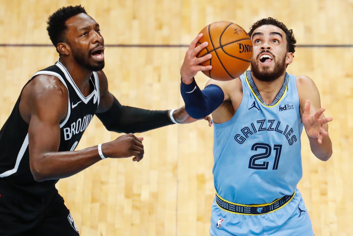 <strong>Grizzlies guard Tyus Jones (right) makes a layup in front of Brooklyn&rsquo;s Jeff Green (left) on Friday, Jan. 8, 2021.</strong> (Mark Weber/The Daily Memphian)