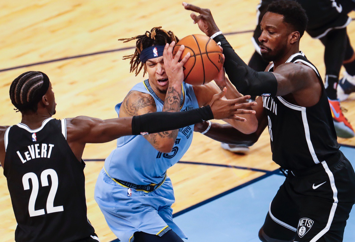 <strong>Grizzlies forward Brandon Clarke (middle) drives the lane against Brooklyn&rsquo;s Caris LeVert (left) and Jeff Green (right) on Friday, Jan. 8, 2021.</strong> (Mark Weber/The Daily Memphian)