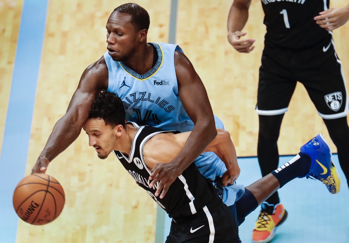 <strong>Grizzlies center Gorgui Dieng (top) tries to save the ball from going out of bounds while battling Brooklyn&rsquo;s Landry Shamet (bottom) on Friday, Jan. 8, 2021.</strong> (Mark Weber/The Daily Memphian)