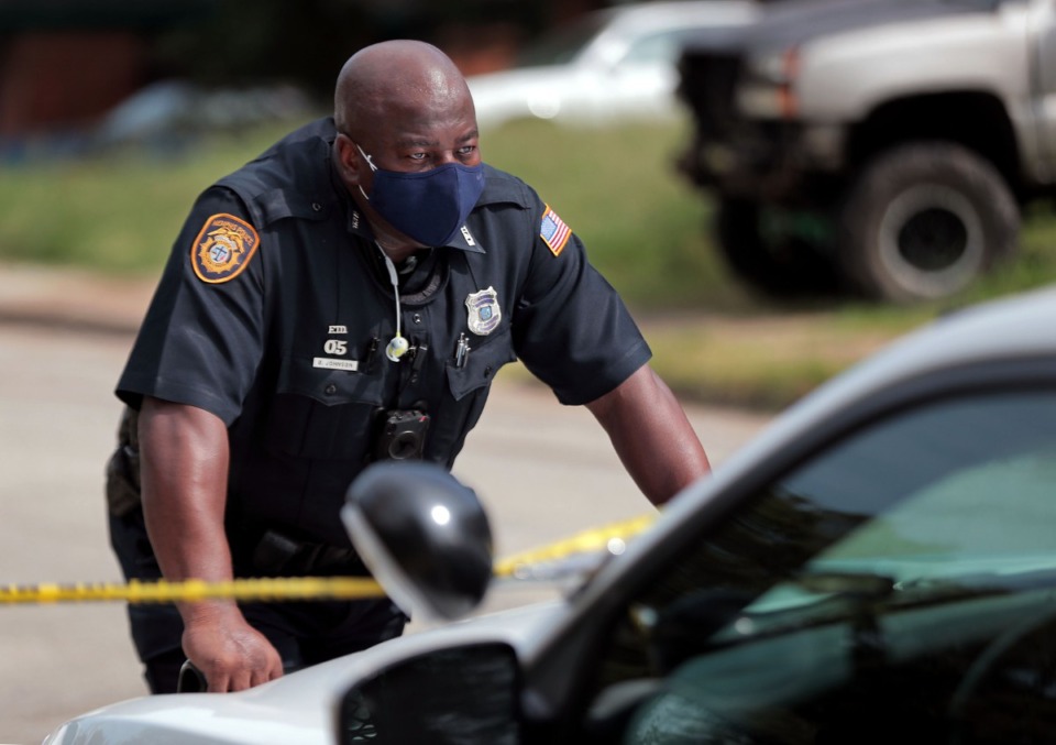<strong>Memphis Police Officer B. Johnson stares off into the distance while responding to a homicide call in North Memphis Sept. 17, 2020.</strong> (Patrick Lantrip/Daily Memphian)