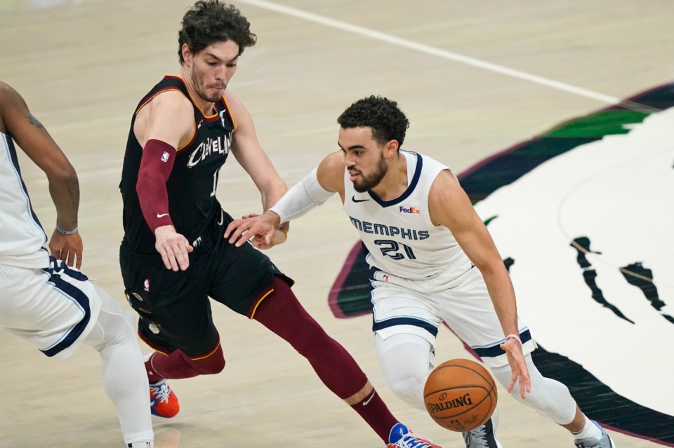 <strong>The Grizzlies' Tyus Jones (21) drives past Cleveland&rsquo;s Cedi Osman (16) on Jan. 11, 2021, in Cleveland.</strong> (Tony Dejak/AP)