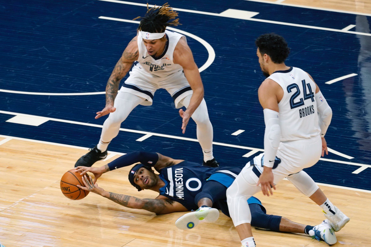 <strong>Minnesota Timberwolves' D'Angelo Russell (0) tries to grab the ball after falling while double-teamed by Memphis Grizzlies' Brandon Clarke and Dillon Brooks on Wednesday, Jan. 13, 2021, in Minneapolis.</strong> (Jim Mone/AP)
