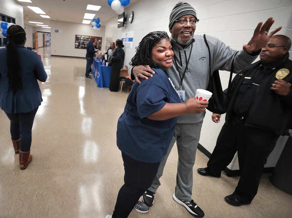 <strong>Kirby High School teachers Denett Davis (center) and Rorey Lawrence greet each other and fellow faculty and staff as they prepare on Friday, Jan. 4, 2019, for an open house at the school which is reopening Monday after a rat infestation forced Shelby County Schools to close the campus last year and temporarily relocate students.</strong> (Jim Weber/Daily Memphian)
