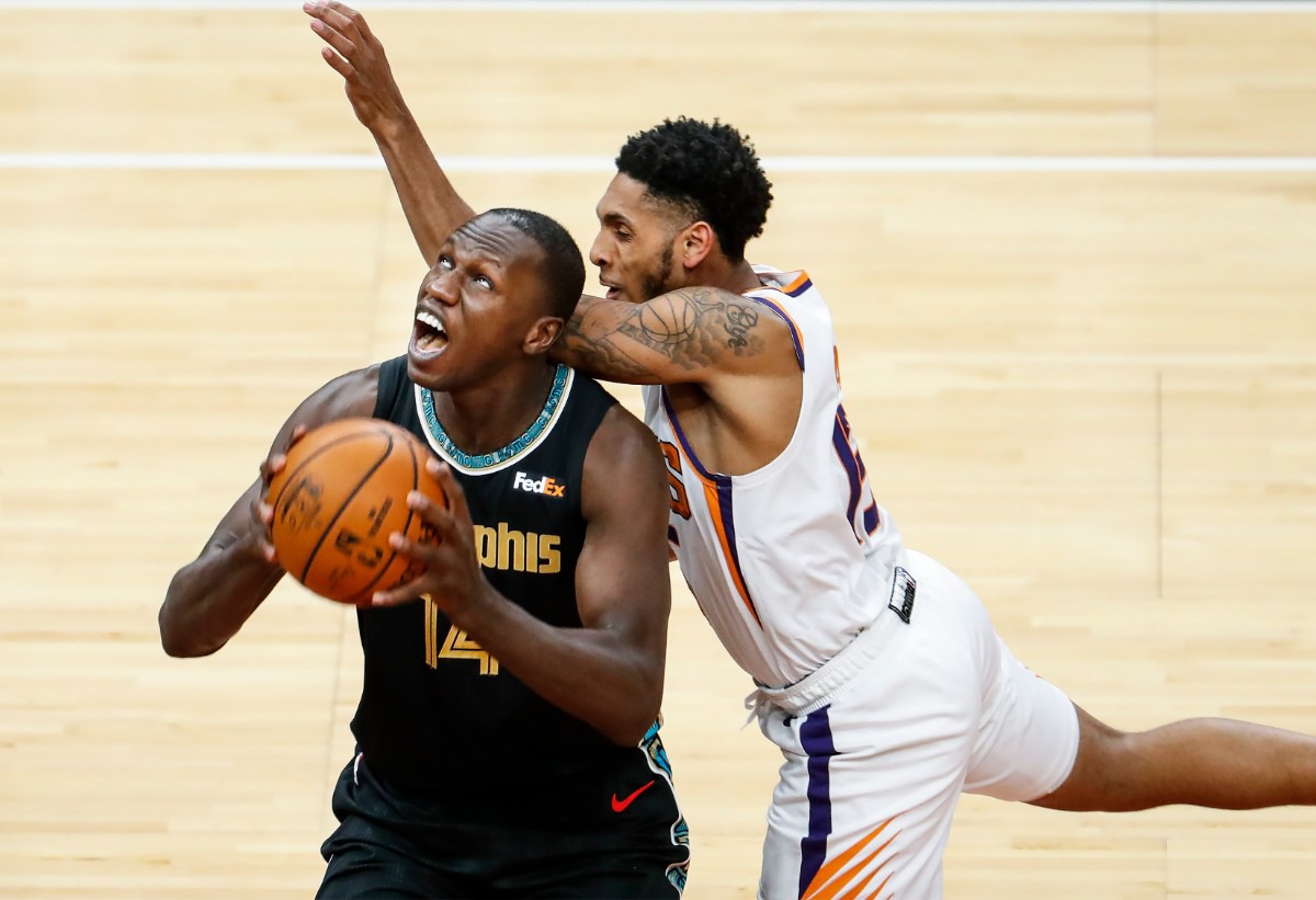<strong>Memphis Grizzlies center Gorgui Dieng (left) is fouled by Phoenix Suns defender Cameron Payne (right) during action on Monday, Jan. 18, 2021.</strong> (Mark Weber/The Daily Memphian)