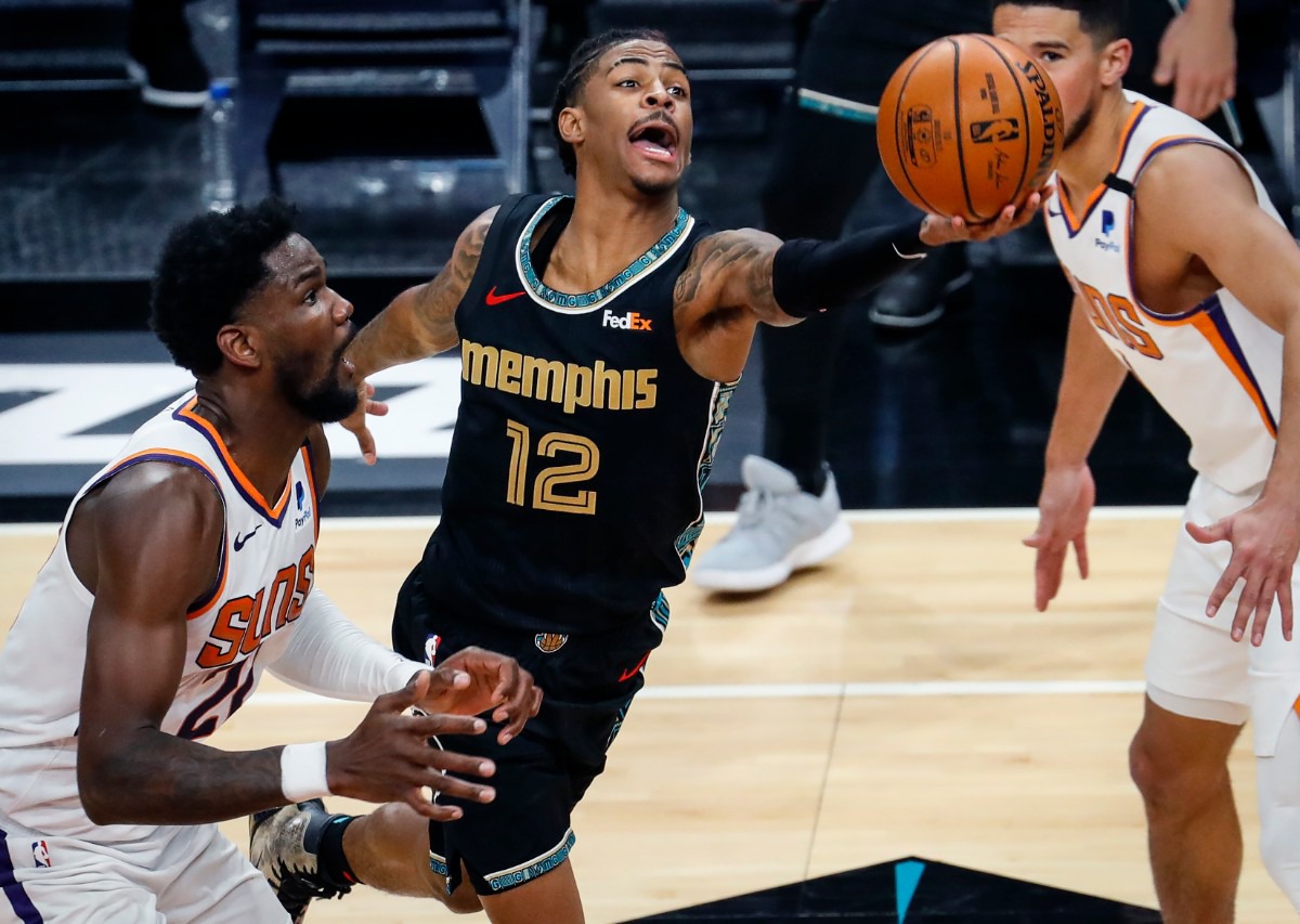 <strong>Memphis Grizzlies guard Ja Morant (middle) drives for a layup in front of Phoenix Suns defender Deandre Ayton (left) during action on Monday, Jan. 18, 2021.</strong> (Mark Weber/The Daily Memphian)