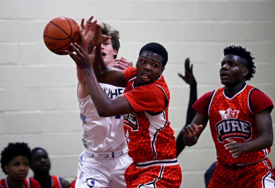 <strong>PURE Youth Athletics Alliance guard Jacob Roberts (4) fights for a loose ball during a Jan. 19, 2020, game against MHEA at East Side Baptist Church.</strong> (Patrick Lantrip/Daily Memphian)