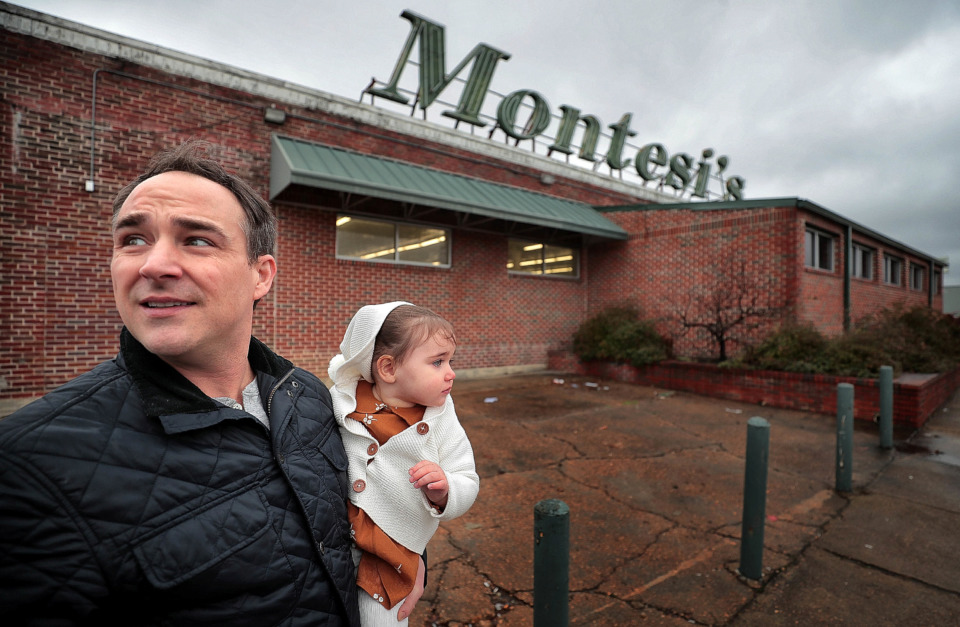 <strong>Reed Herrmann, holding his 1-year-old daughter Vivien, is opening a furniture business in the former Montesi's grocery building on Summer. The new store, called Furniture Central, will feature liquidated hotel furniture, close-outs and new pieces.</strong> (Jim Weber/Daily Memphian)