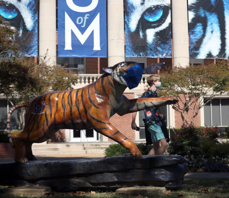 A University of Memphis student walks past a tiger statue on campus Oct. 13, 2020. (Patrick Lantrip/Daily Memphian file)