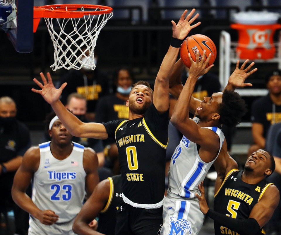 <strong>University of Memphis forward DeAndre Williams (12) goes up for a basket over Wichita State Shockers guard Dexter Dennis (0) on Jan. 21, 2021, at the FedExForum.</strong> (Patrick Lantrip/Daily Memphian)