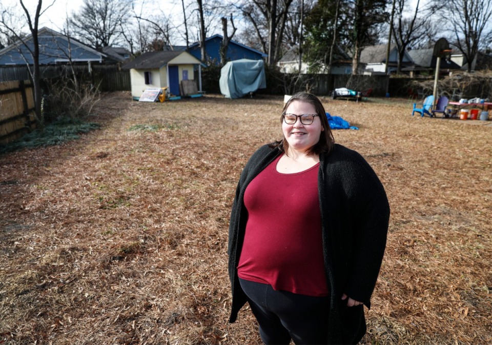 <strong>Marisa Mender-Franklin stands in a neighbor&rsquo;s backyard on Monday, Jan. 18, 2021, where she will soon plant a flower garden. Mender-Franklin recently posted in the Facebook group &ldquo;Buy Nothing Midtown/Downtown,&rdquo; asking if she could plant flowers on someone&rsquo;s property to grow and sell. She received numerous replies.</strong> (Mark Weber/Daily Memphian)
