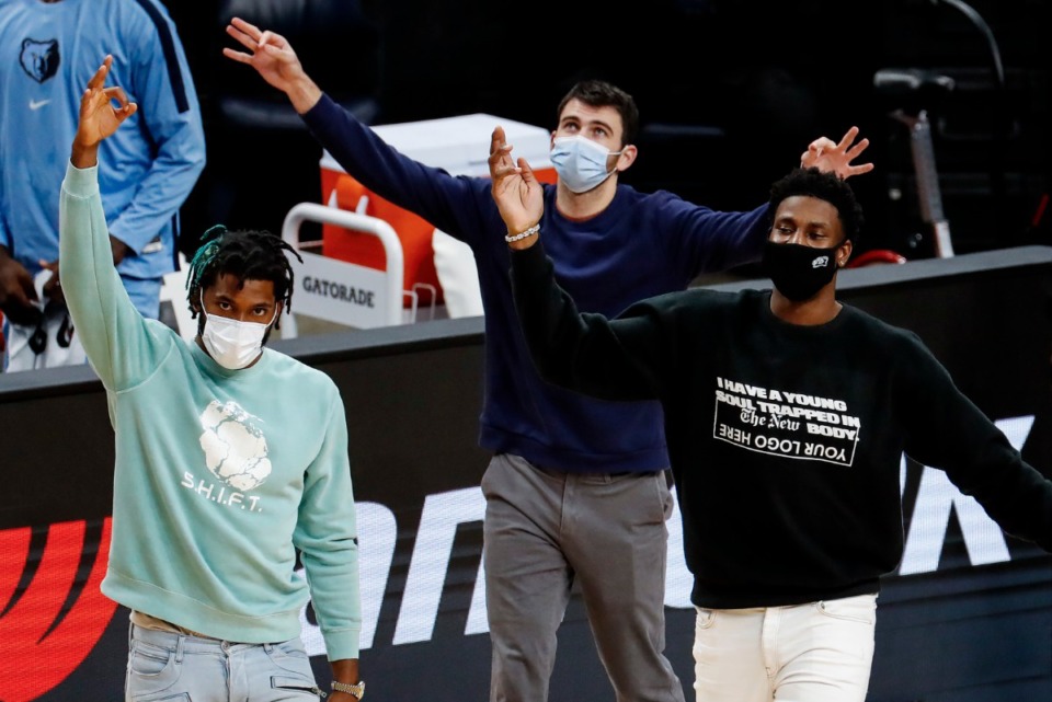 <strong>Memphis Grizzlies teammates Justise Winslow (from left), John Konchar and Jaren Jackson Jr. celebrate on the sidelines during a game against the Brooklyn Nets on Friday, Jan. 8.</strong> (Mark Weber/Daily Memphian)