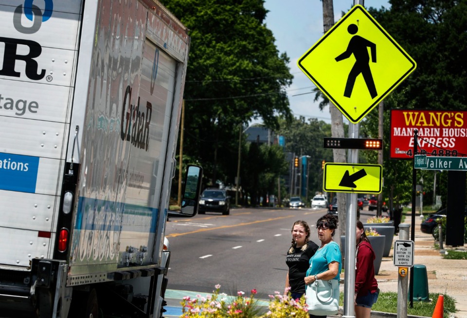 <strong>Pedestrians wait for traffic to stop before using the new Highland Strip crosswalk on June 26, 2019.</strong> (Mark Weber/Daily Memphian file)