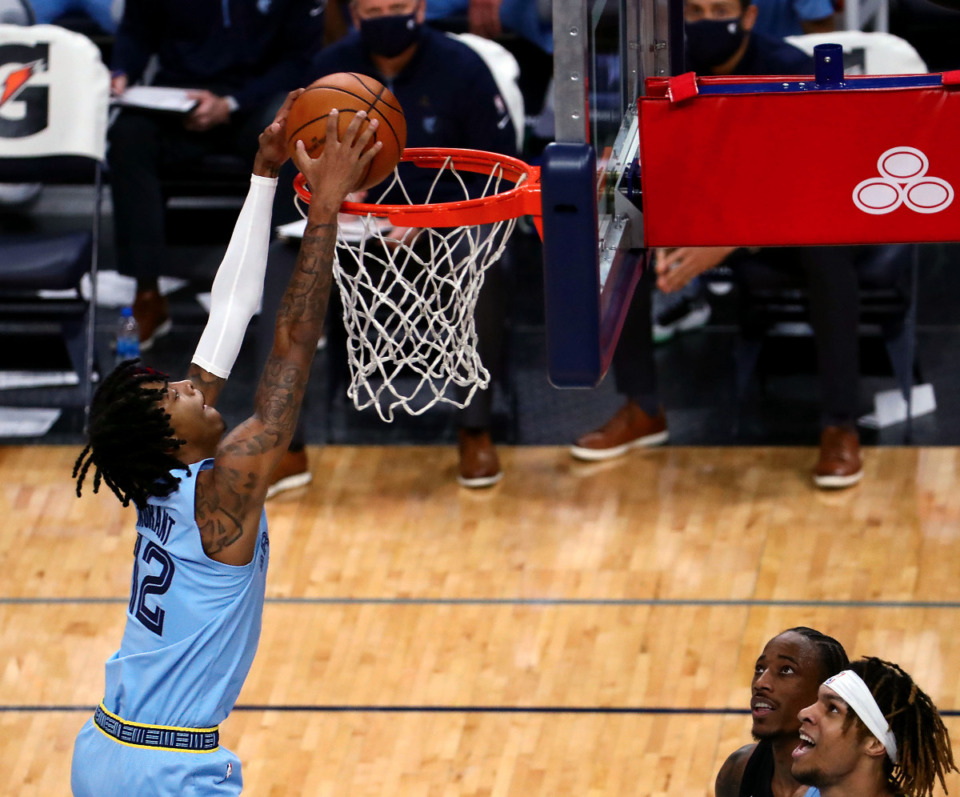 <strong>Memphis Grizzles guard Ja Morant (2) connects on an off the backboard dunk during a Dec. 23, 2020 home game against the San Antonio Spurs.</strong> (Patrick Lantrip/Daily Memphian file)