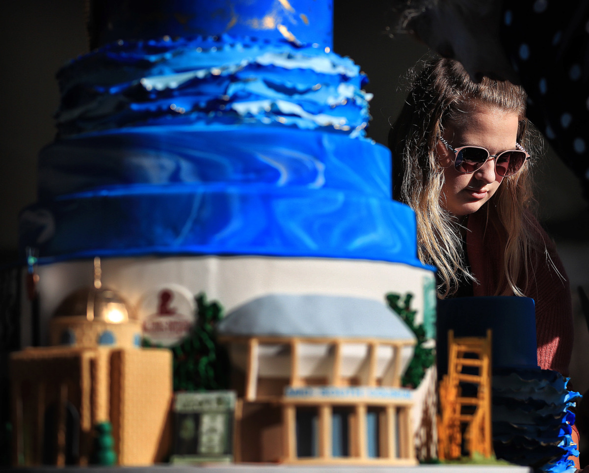 <strong>Sydney Laird with Cakes by Mom and Me helps dismantle and cut the birthday cake, which was built to represent 200 years of Memphis history, as Elvis fans gather at Graceland on Jan. 8, 2019, to celebrate the King of Rock &rsquo;n&rsquo; Roll&rsquo;s 84th birthday.</strong> (Jim Weber/Daily Memphian)