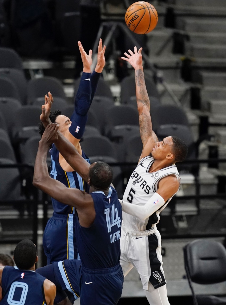 <strong>San Antonio Spurs guard Dejounte Murray (5) shoots over Memphis Grizzlies center Gorgui Dieng (14) and guard Dillon Brooks (24) in San Antonio, Monday, Feb. 1, 2021.</strong> (Eric Gay/AP)