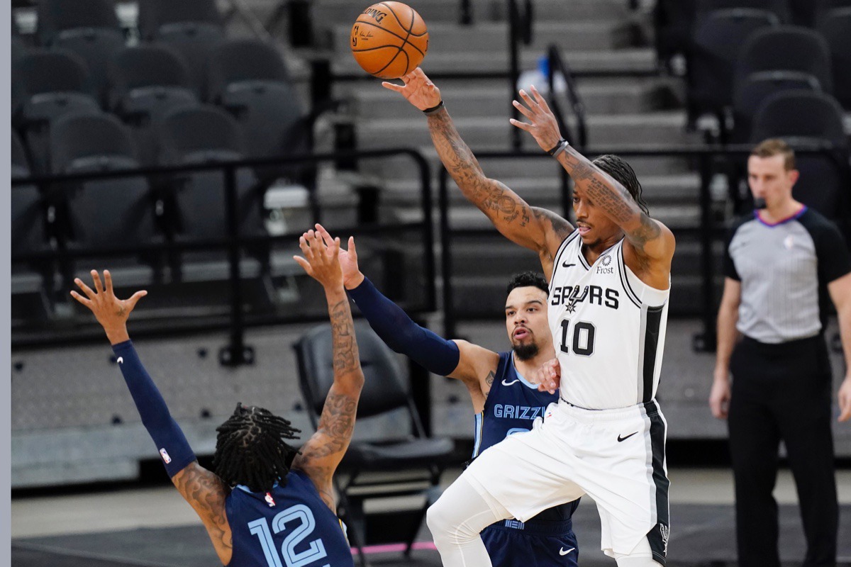 <strong>San Antonio Spurs forward DeMar DeRozan (10) passes the ball over Memphis Grizzlies guard Ja Morant (12) in San Antonio, Monday, Feb. 1, 2021.</strong>&nbsp;(Eric Gay/AP)