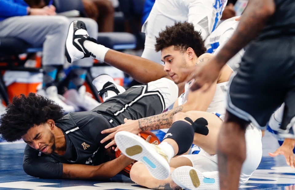 <strong>Tigers defender Lester Quinones (right) fights UCF forward Isaiah Adams (left) for a loose ball on Feb. 1, 2021.</strong> (Mark Weber/The Daily Memphian)