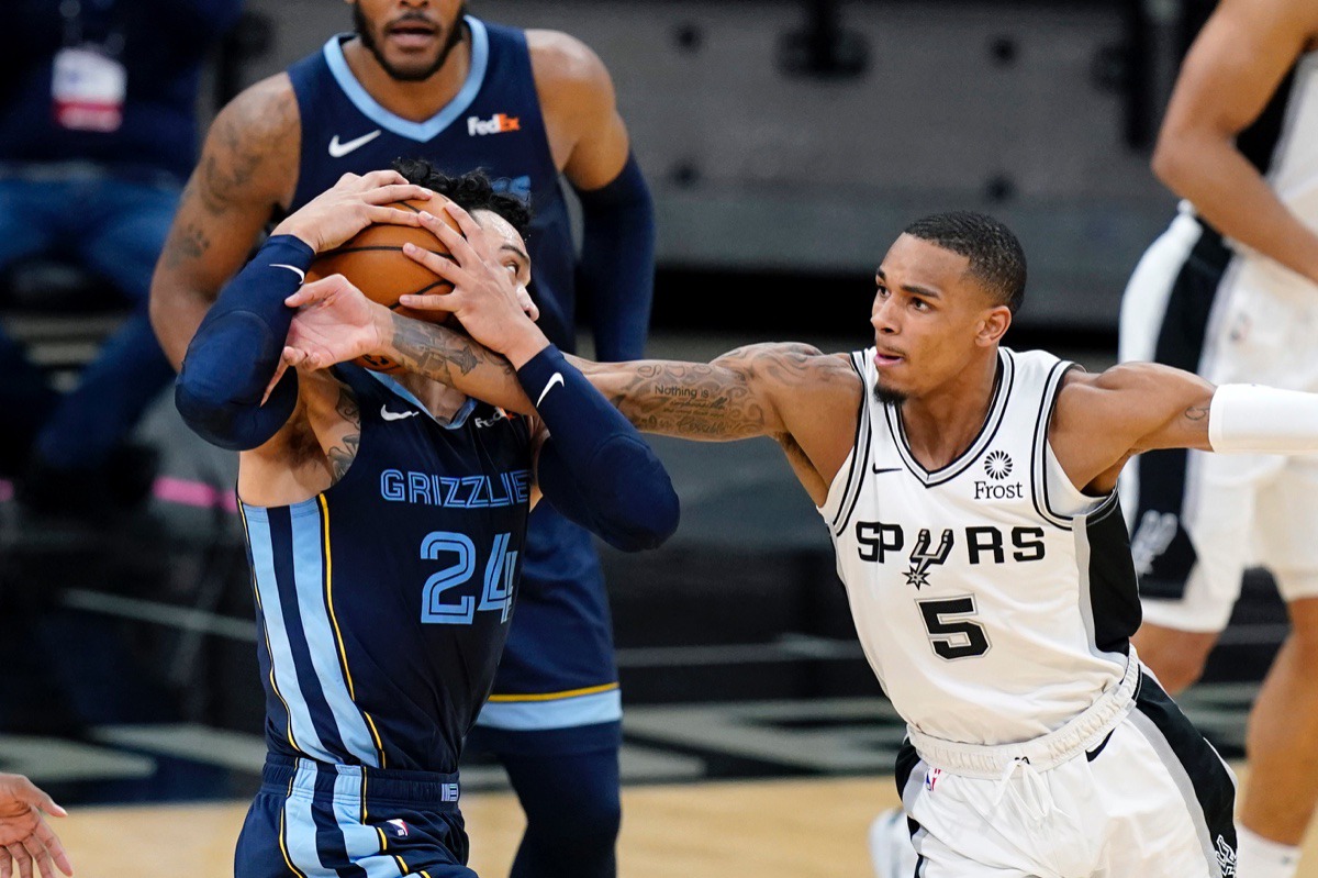 <strong>San Antonio Spurs guard Dejounte Murray (5) reaches in on Memphis Grizzlies guard Dillon Brooks (24) in San Antonio, Monday, Feb. 1, 2021.</strong> (Eric Gay/AP)