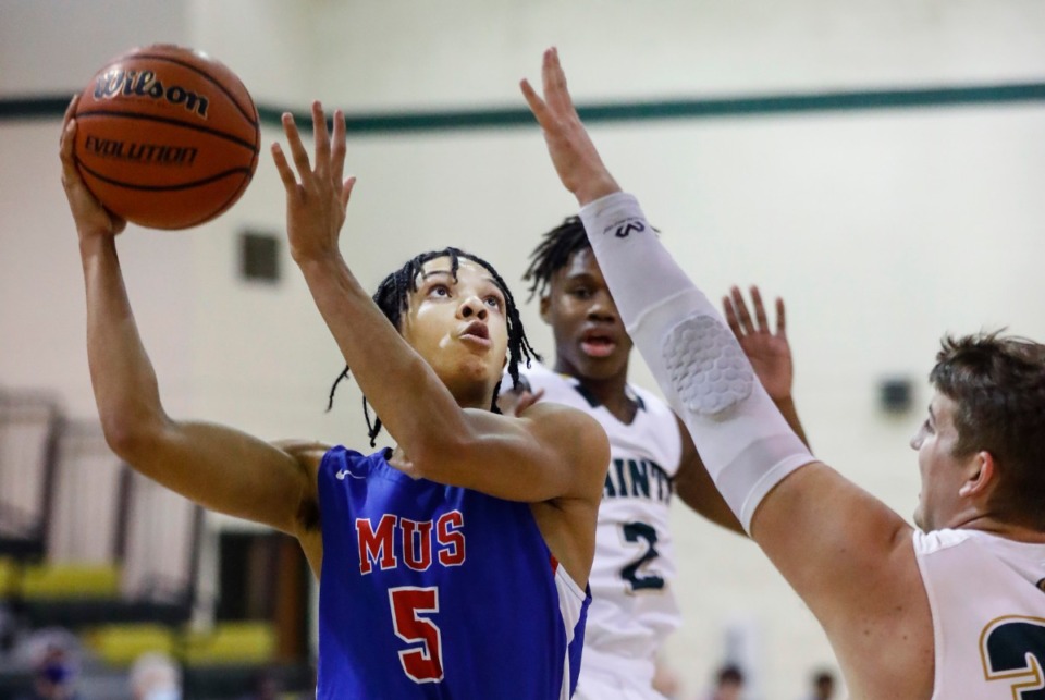 <strong>MUS guard Curtis Givens (left) drives to the basket against the Briarcrest defense Tuesday.</strong> (Mark Weber/The Daily Memphian)