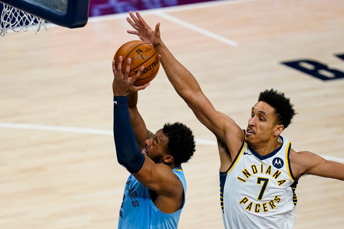 <strong>Memphis Grizzlies forward Xavier Tillman Sr. (2) shoots in front of Indiana Pacers guard Malcolm Brogdon (7) in Indianapolis on Tuesday, Feb. 2, 2021.</strong> (/Michael Conroy/AP)