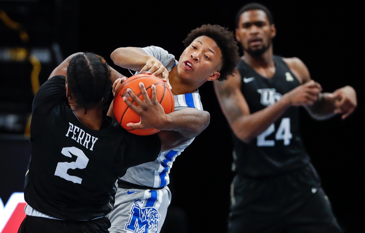 <strong>Boogie Ellis (middle) tries to steal the ball from UCF guard Darius Perry (left) on Wednesday, Feb. 3, 2021.</strong> (Mark Weber/The Daily Memphian)