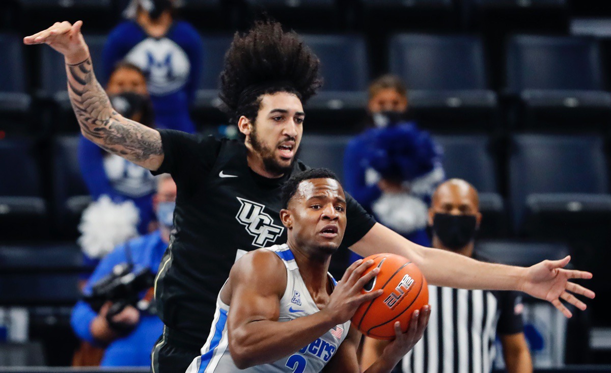 <strong>Guard Alex Lomax (front) grabs a rebound in front of UCF forward Avery Diggs (back) on Wednesday, Feb. 3, 2021.</strong> (Mark Weber/The Daily Memphian)