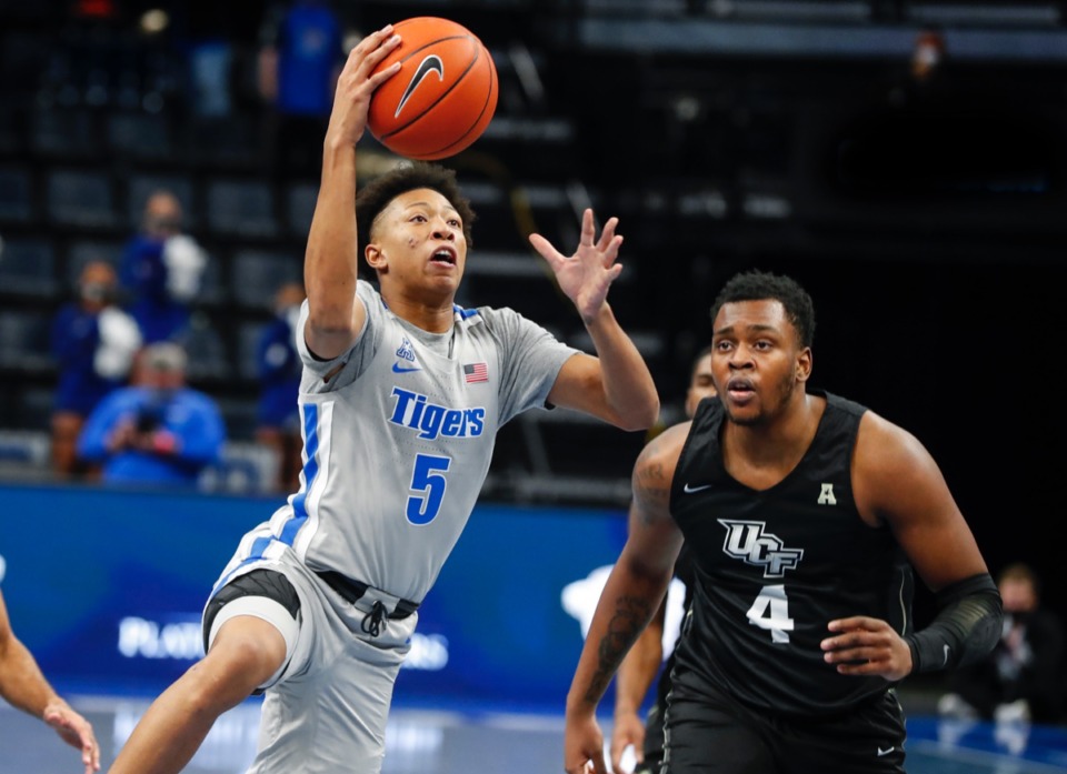 <strong>Tigers guard Boogie Ellis (left) drives for a layup against UCF&rsquo;s Jamille Reynolds (right) on Wednesday, Feb. 3, 2021.</strong> (Mark Weber/The Daily Memphian)