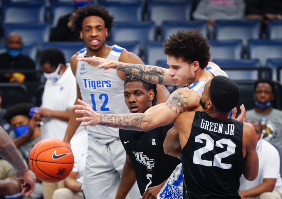 <strong>Tigers guard Lester Quinones (right) loses the ball while attempting a rebound against UCF on Wednesday, Feb. 3, 2021.</strong> (Mark Weber/The Daily Memphian)