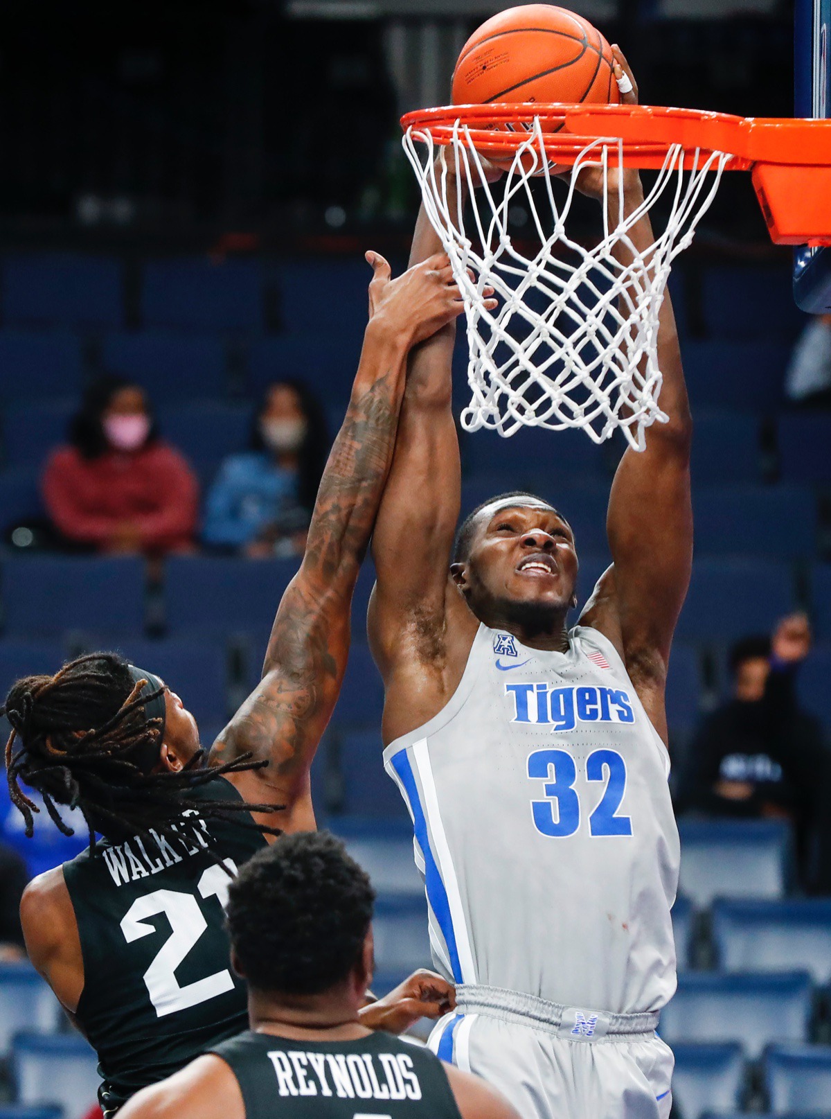 <strong>Tigers center Moussa Cisse (right) is fouled while attempting a dunk against UCF on Wednesday, Feb. 3, 2021.</strong> (Mark Weber/The Daily Memphian)