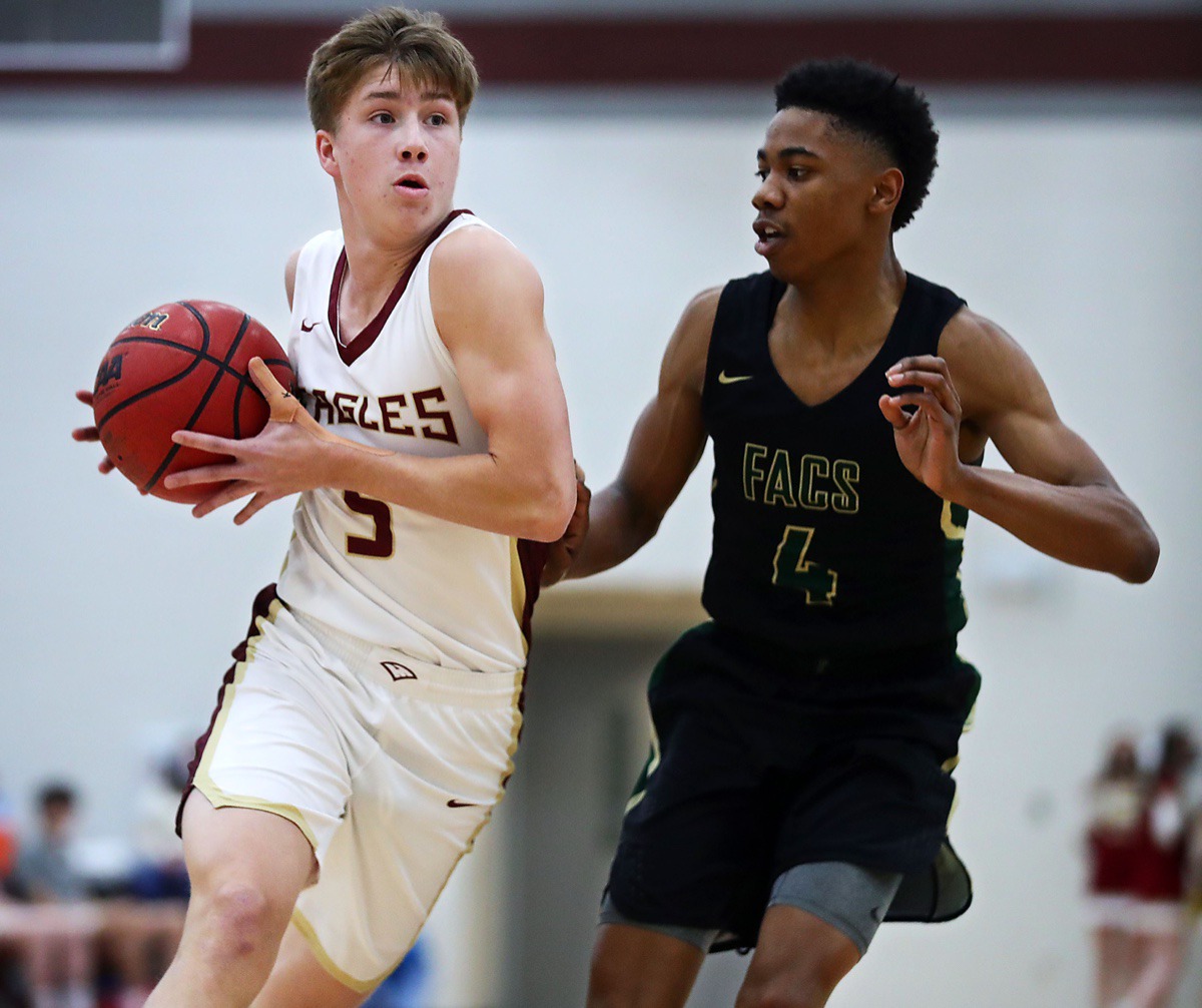 <strong>ECS guard Mason Shropshire (5) drives to the basket against FACS guard Joshua Ward (4).</strong> (Patrick Lantrip/Daily Memphian)