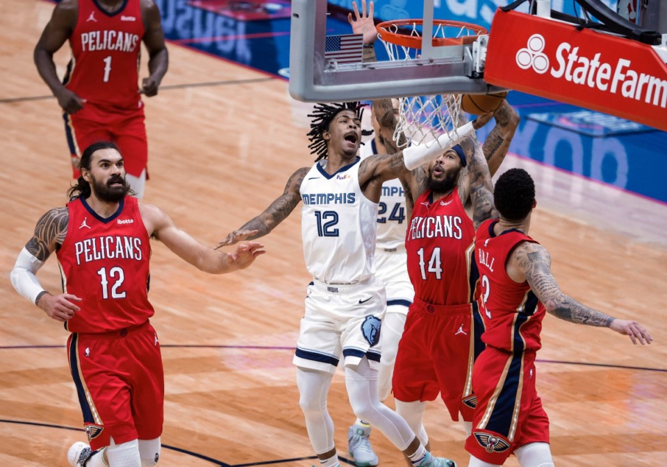 <strong>Memphis Grizzlies guard Ja Morant (12) shoots past New Orleans Pelicans center Steven Adams (12), forward Brandon Ingram (14) and guard Lonzo Ball (2) during the third quarter of an NBA basketball game in New Orleans, Saturday, Feb. 6, 2021.</strong> (Derick Hingle/AP)