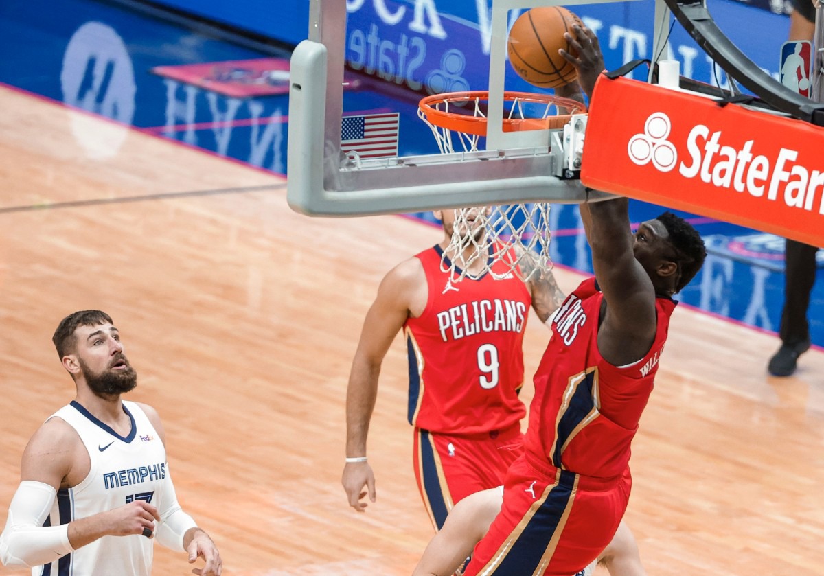 <strong>New Orleans Pelicans forward Zion Williamson (1) dunks as Memphis Grizzlies center Jonas Valanciunas (17) watches during the first quarter of an NBA basketball game in New Orleans, Saturday, Feb. 6, 2021.</strong> (Derick Hingle/AP)