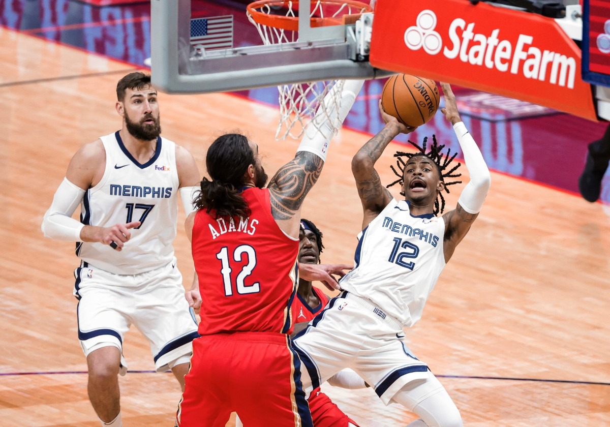 <strong>Memphis Grizzlies guard Ja Morant (12) shoots over New Orleans Pelicans center Steven Adams (12) and guard Kira Lewis Jr. during the third quarter of an NBA basketball game in New Orleans, Saturday, Feb. 6, 2021.</strong> (Derick Hingle/AP)