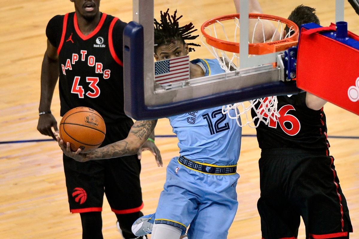 <strong>Memphis Grizzlies guard Ja Morant (12) shoots against Toronto Raptors center Aron Baynes (46) at FedExForum on Feb. 8, 2021.</strong> (AP Photo/Brandon Dill)