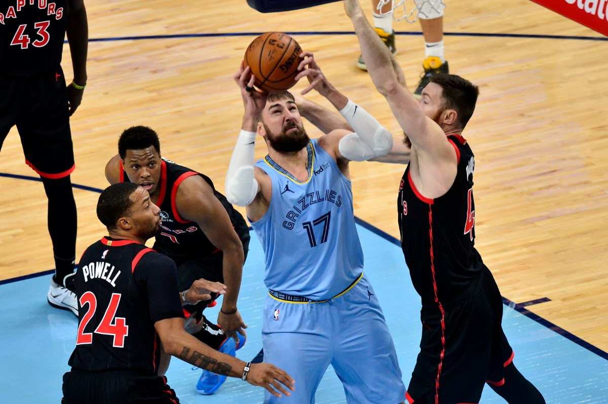 <strong>Memphis Grizzlies center Jonas Valanciunas (17) handles the ball against Toronto Raptors center Aron Baynes as guards Norman Powell (24) and Kyle Lowry (7) move for position at FedExForum on Feb. 8, 2021.</strong> (Brandon Dill/AP)
