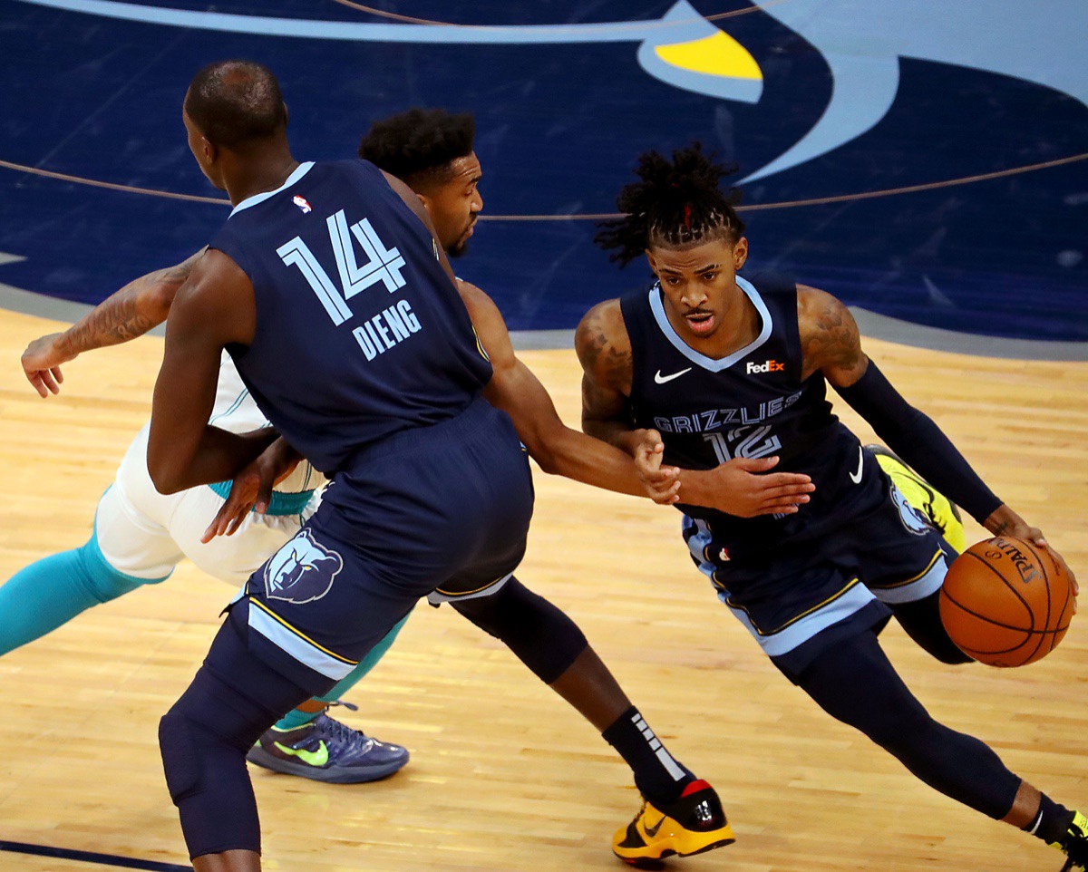 <strong>Memphis Grizzles guard Ja Morant (2) fights through a screen during the Feb. 10 game at FedExForum against the Charlotte Hornets.</strong> (Patrick Lantrip/Daily Memphian)
