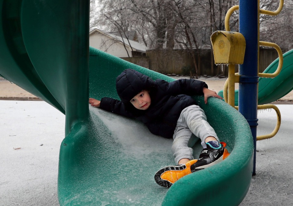 <strong>Four-year-old Tristan Cook slides down an icy slide a little faster than he anticipated at Williamson Park in Midtown Feb. 11, 2021</strong>. (Patrick Lantrip/Daily Memphian)