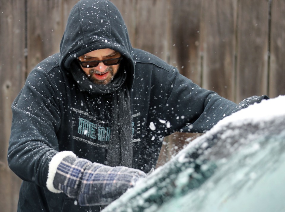 <strong>Hunter Coleman scrapes ice off of his windshield Feb. 11, 2021.</strong> (Patrick Lantrip/Daily Memphian)