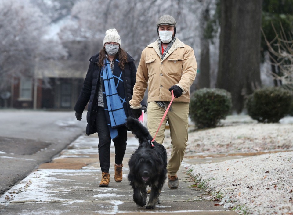 <strong>Olivia and Caleb Fowler walk their dog, Red, down Avalon Street on Thursday, Feb. 11, after freezing rain fell overnight in Memphis and Shelby County. The National Weather Service is forecasting snow, freezing rain and sleet in the coming days.</strong> (Patrick Lantrip/Daily Memphian)
